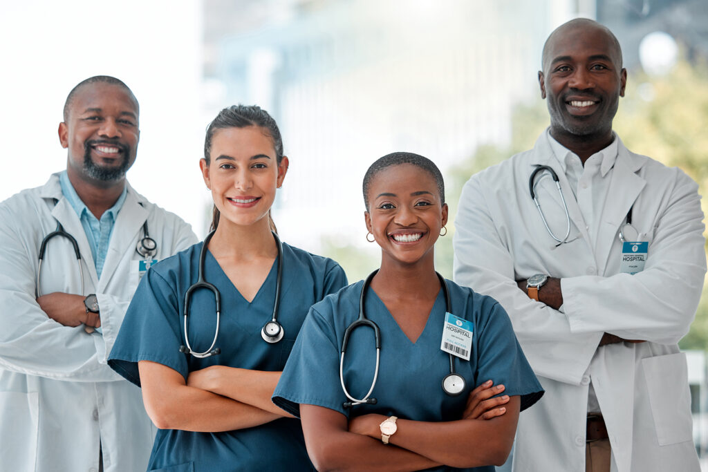 Jennifer John Carbon – Confident healthcare team smiling in hospital setting